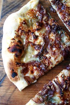 
21. Fig Squares Stretch dough into a 15-by-9-inch rectangle. Sprinkle with cardamom. Cut into small squares; top each with a fig half and a dollop of robiola. Bake, then top with caramelized onions.