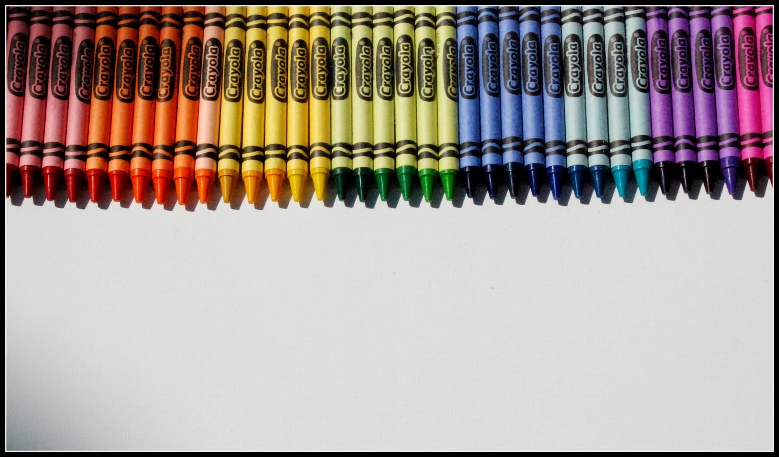 Start off by lining up all the crayons and glueing them on to the board 