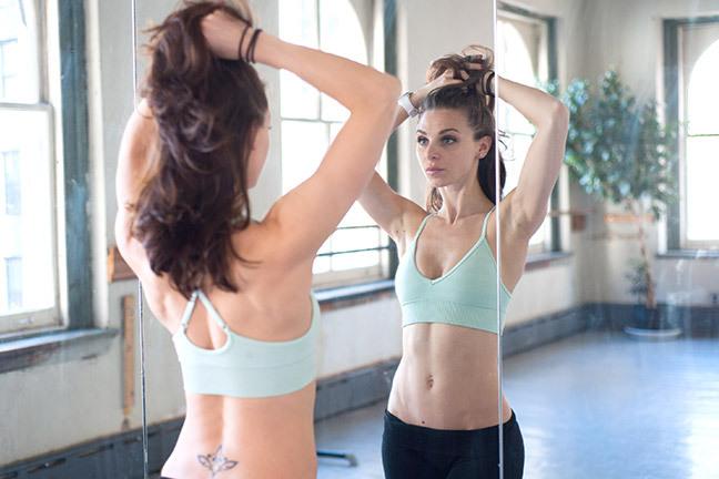 I massage this onto my frizzies and my ends when I workout.  It sounds like the opposite of what you do since you may sweat, but this is heat activated. It repairs your hair while you workout and smoothes frizzies afterward.