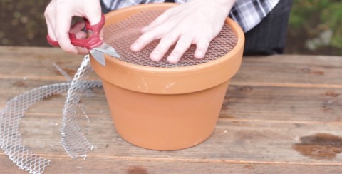 2. Next, you need a surface to cook on—any type of metal mesh should work. Cut it in a circle so that it's a similar size to the top of your clay pot. Put aside for later.