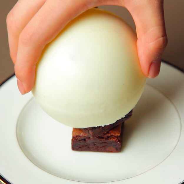 7. Gently place the chocolate bomb over the stack: