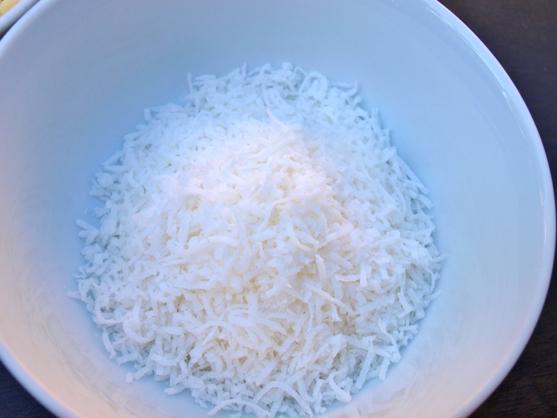 Now add some of the coconut sprinkles into a bowl and once you have rolled your mixture into little balls, cover them with the sprinkles by rolling them in the bowl.