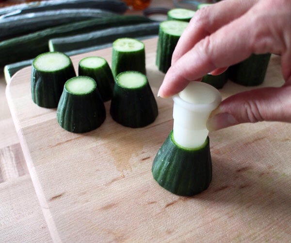 Use small circle cookie cutters to put centered circle impressions on the what will be the tops of your sections.  You'll use these as guides when you cut out the cup cavities. Try to pick a cutter size that leaves at least 1/8" to 3/16" cucumber 'flesh' around the edge for a substantial enough wall