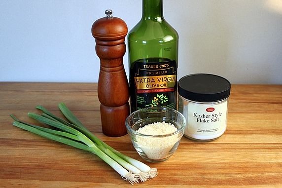Step 1. Assemble these ingredients: green onions, black pepper, olive oil, grated Parmesan cheese, kosher salt 
