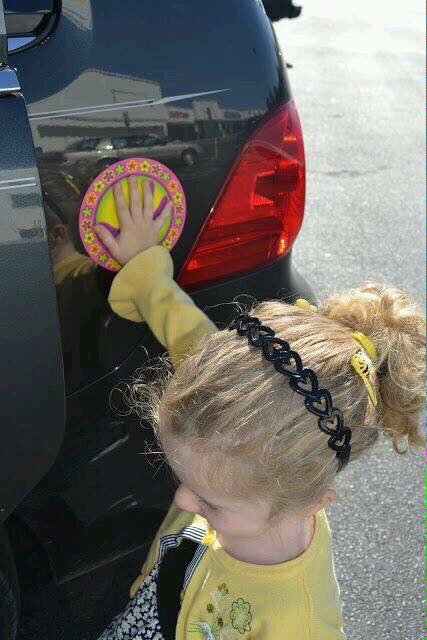 Put stickers on the side of the vehicle so your child will put their hands on and wait till your finish and so you will know where they are at an not behind