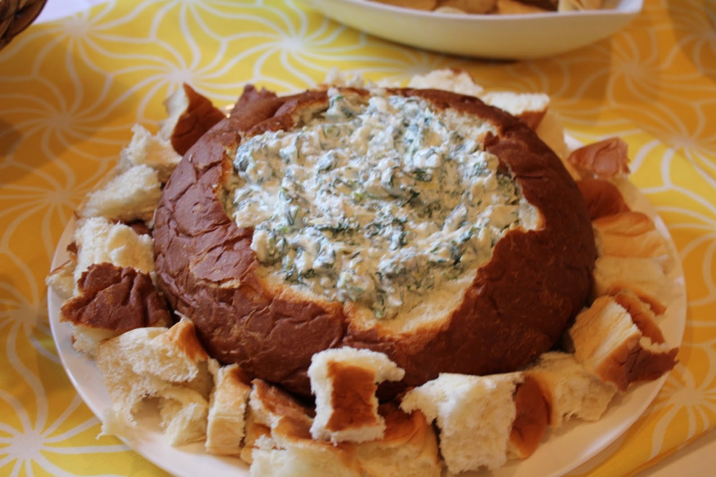 In a large bowl combine thawed frozen spinach (one package) one cup of mayo, one container of sour cream, one packet of knorrs vegetable soup mix. If you mix together and put in a bread bowl it's great for parties in summer!