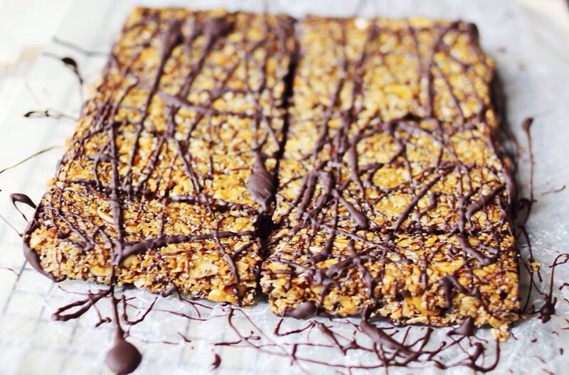 Now lay a piece of wax paper over the bars and lightly press it into the chocolate. Invert a cooling rack and place it on top, then flip the bars onto the cooling rack so that the chocolate is now on the bottom.