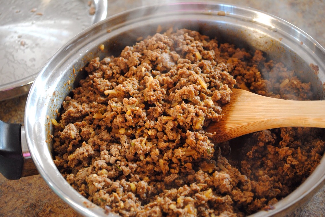 While potatoes are cooking, take out a pan, put in some ground meat and then taco seasoning! Cook the meat up!