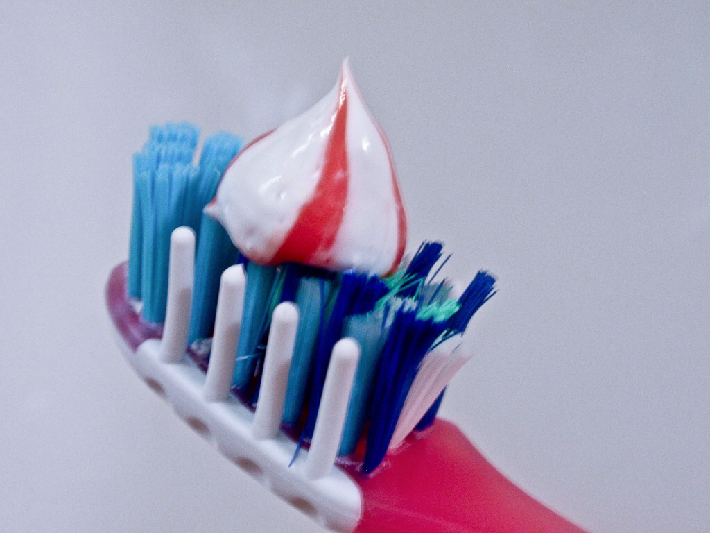 Run your toothbrush under cold water and add pea sized toothpaste . Use a whitening toothpaste