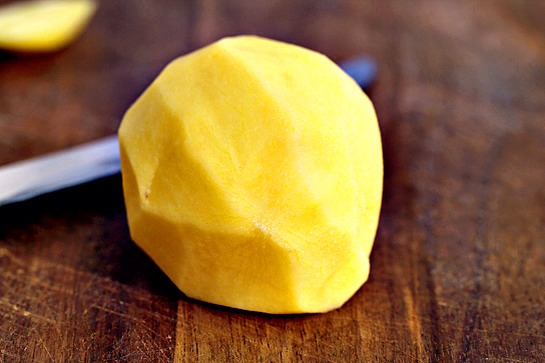 4. Lay the potato flat on its cut side.