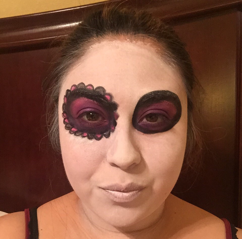 1) paint your entire face white 
2)carefully draw a circle starting from the top of your brow and follow your eye socket around  
3) smudge out the black circle and fill with whatever color you choose!
4) start your scalloping around your eye and fill with color or leave blank. I chose to fill mine!