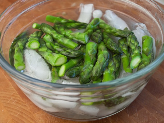 The best way to preserve the bright green color of the tips and keep them crisp is to shock them in an ice bath, but this is probably only worth it if you’re entertaining. Otherwise, just refresh the tips under cold water.