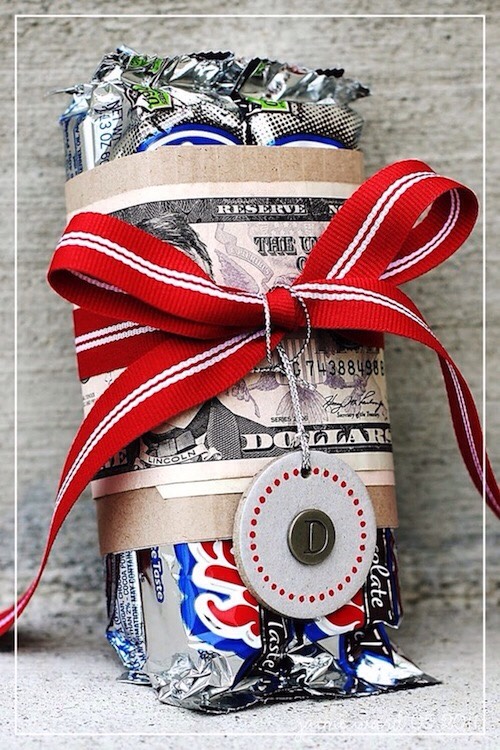 25. Creative Gift Wrap
Sometimes it’s all about the packaging! This is such a great idea for someone who is hard to shop for, like teenage boys. You just can’t go wrong with money and candy. And, it doesn’t get much easier than this.