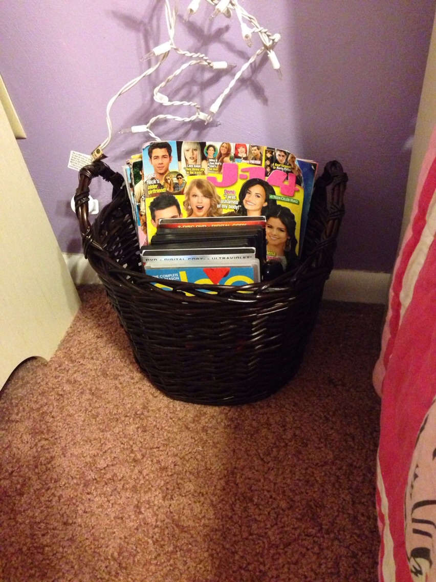 I took this walmart basket and put all my magazines in it and I put my movies and tv remotes in it. It looks a lot cuter than a pile of magazines and movies sitting in the middle of my floor. I also keep my phone charger wrapped up in here then it is outta the way.
