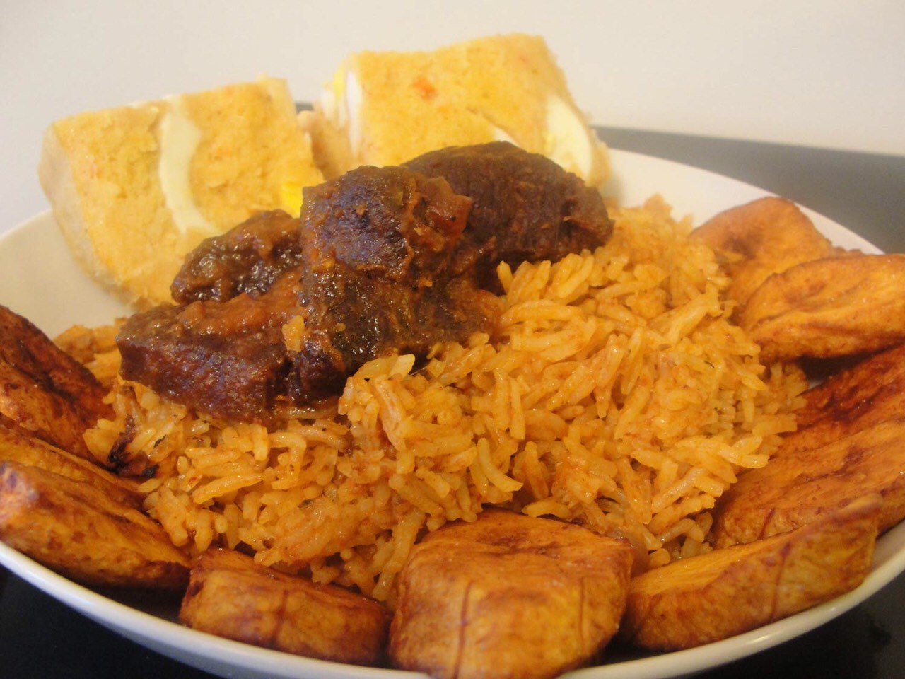 Jollof rice with plantain and stewed beef